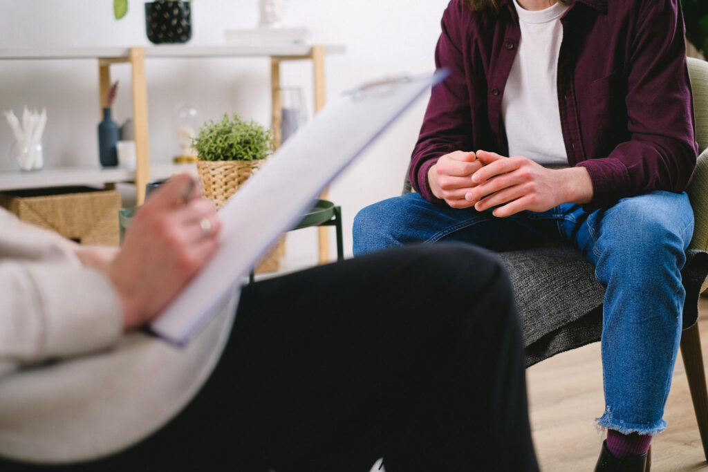 Therapist and client discussing issues in a psychotherapy session, highlighting mental health support.